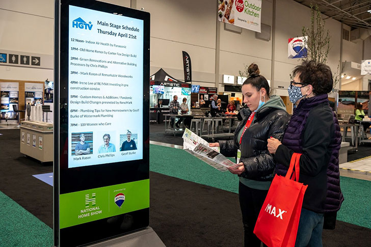 Portable digital billboard with the Home Show Main Stage schedule.
